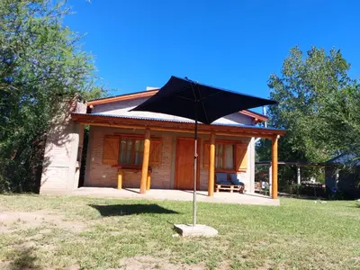 a large black umbrella in front of a house at Azul in Arroyo de Los Patos
