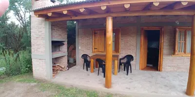 a patio with a table and chairs under a pergola at Azul in Arroyo de Los Patos