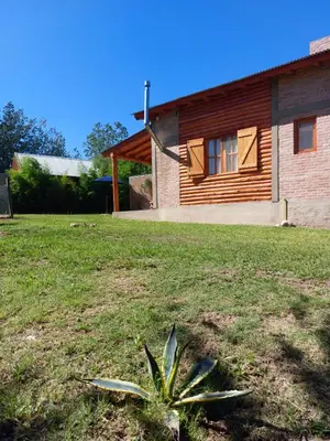 a house with a plant in front of a yard at Azul in Arroyo de Los Patos