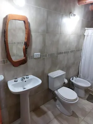 a bathroom with a toilet and a sink and a mirror at Azul in Arroyo de Los Patos