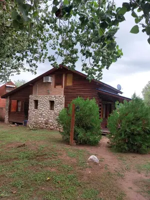 an old log house with a yard in front of it at Azul in Arroyo de Los Patos