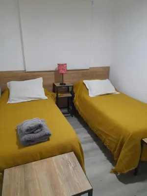 two beds sitting next to each other in a room at CASA CONFORTABLE II in Cordoba
