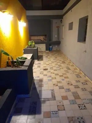 a room with a tile floor and a yellow wall at CASA CONFORTABLE II in Cordoba