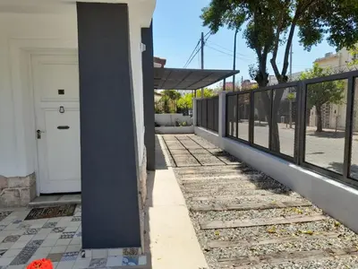 a porch with a fence and a white door at CASA CONFORTABLE II in Cordoba