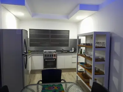 a kitchen with a refrigerator and a table in it at CASA CONFORTABLE II in Cordoba