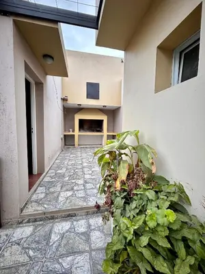 a courtyard of a house with a plant at Departamentos Monteolivos in Merlo