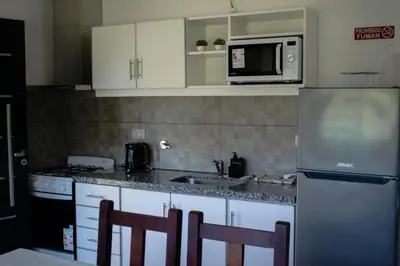 a kitchen with white cabinets and a stainless steel refrigerator at Monteolivos II in El Rincón