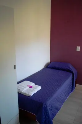 a bedroom with a purple bed with a towel on it at Monteolivos II in El Rincón