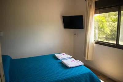 a bedroom with a blue bed with towels on it at Monteolivos II in El Rincón