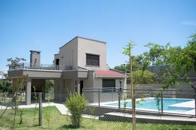 a house with a swimming pool and a fence at Monteolivos II in El Rincón