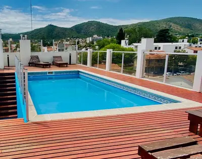 a swimming pool on the roof of a house at Edificio Manantiales in Villa Carlos Paz