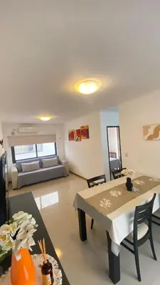 a living room with a table and a couch at Edificio Manantiales in Villa Carlos Paz