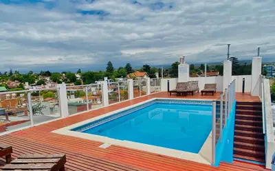 a swimming pool on the roof of a house at Edificio Manantiales in Villa Carlos Paz