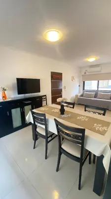 a dining room with a table and chairs and a bed at Edificio Manantiales in Villa Carlos Paz