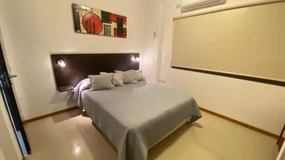 a small bedroom with a bed in a room at Edificio Manantiales in Villa Carlos Paz