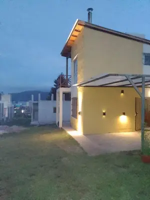 a white house with lights on the side of it at Villa Aurora in Potrero de Garay