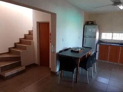 a kitchen with a table and chairs and a refrigerator at Villa Aurora in Potrero de Garay