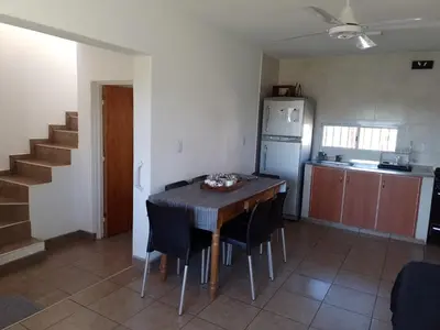 a kitchen with a table and chairs and a refrigerator at Villa Aurora in Potrero de Garay