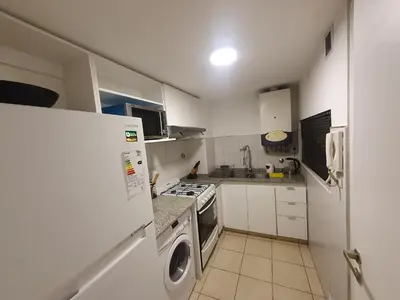 a kitchen with a refrigerator and a stove top oven at LOAN Nueva Cordoba 6A in Cordoba