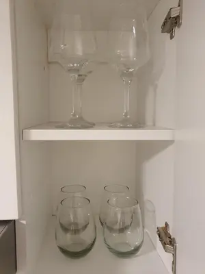 four wine glasses sitting on a shelf in a refrigerator at LOAN Nueva Cordoba 6A in Cordoba
