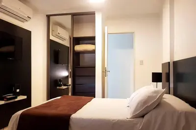 a bedroom with a bed and a door to a closet at LOAN Nueva Cordoba 9E in Cordoba