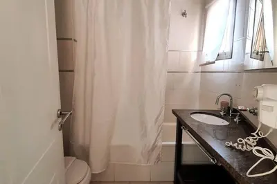 a bathroom with a sink and a shower curtain at LOAN Nueva Cordoba 9E in Cordoba