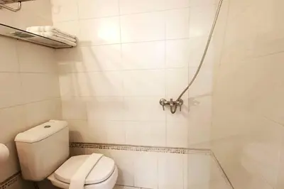 a white bathroom with a toilet and a shower at LOAN Nueva Cordoba 9E in Cordoba