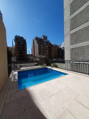 a swimming pool on the roof of a building at LOAN Nueva Cordoba 9E in Cordoba