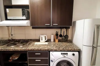 a kitchen with a refrigerator and a washing machine at LOAN Nueva Cordoba 9E in Cordoba