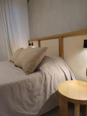 a bed with a pillow and a table in a room at LOAN Nueva Cordoba categoría appart 7B in Cordoba