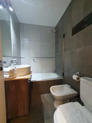 a bathroom with a sink and a toilet and a tub at LOAN Nueva Cordoba categoría appart 7B in Cordoba
