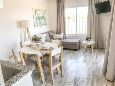 a living room with a table and a couch at Cabañas Titina's Lake in Potrero de Garay