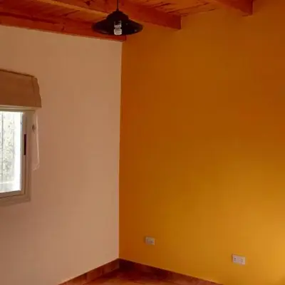 a room with yellow walls and a ceiling at Departamento Estancia Vieja 74 PA in Estancia Vieja