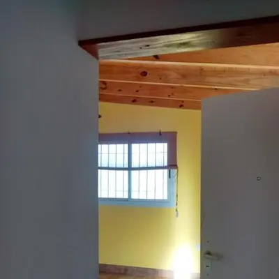 a room with a window in a room with yellow walls at Departamento Estancia Vieja 74 PA in Estancia Vieja