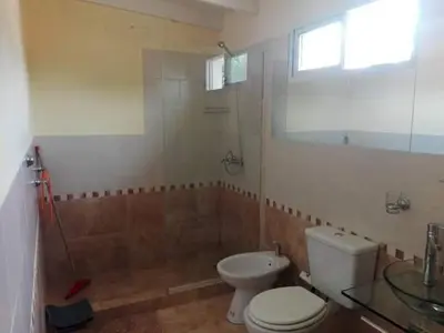 a bathroom with a toilet and a shower and a sink at Complejo Mirador de las Sierras pileta climatizada al aire libre in San Javier