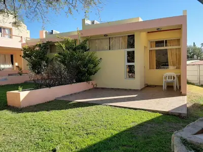 a house with a lawn in front of it at Complejo Mirador de las Sierras pileta climatizada al aire libre in San Javier