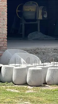 a row of cement bowls with metal handles on the ground at Complejo Mirador de las Sierras pileta climatizada al aire libre in San Javier