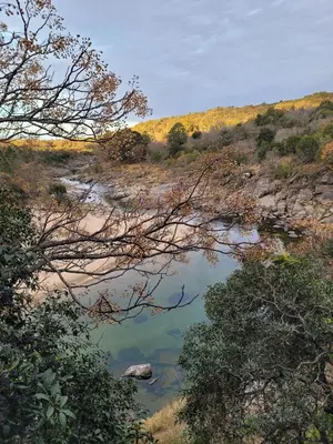 a river in the middle of a field with trees at Casa Filomena in Villa Canada del Sauce