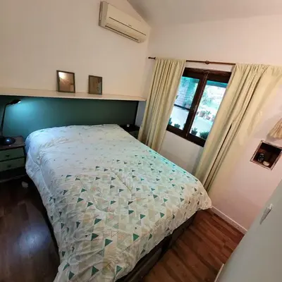 a bedroom with a bed and a window at Casa Filomena in Villa Canada del Sauce