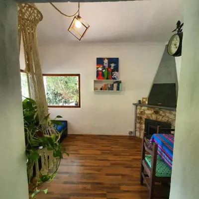 a living room with a fireplace and a clock on the wall at Casa Filomena in Villa Canada del Sauce