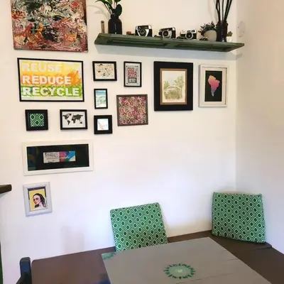 a room with two chairs and pictures on a wall at Casa Filomena in Villa Canada del Sauce