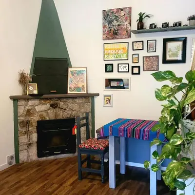 a living room with a table and a fireplace at Casa Filomena in Villa Canada del Sauce