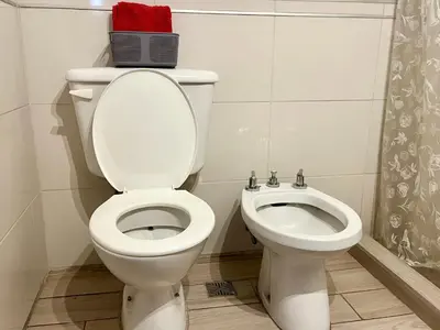 a white toilet and a bidet in a bathroom at Hermoso departamento en el centro de Cordoba, somos ApartamentosCordoba in Cordoba