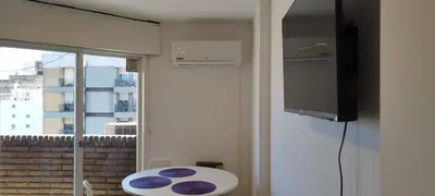 a room with a window and a table and a tv at Hermoso departamento en el centro de Cordoba, somos ApartamentosCordoba in Cordoba