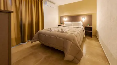 a bedroom with a large bed in a room at Wooden Hotel in Villa Carlos Paz