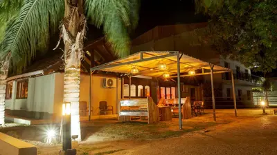 a tent in front of a house at night at Wooden Hotel in Villa Carlos Paz