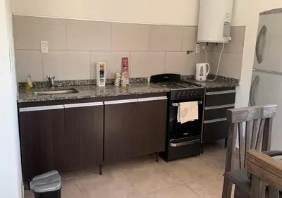 a kitchen with a sink and a stove top oven at Alquiler temporal casa Bialet Masse con pileta, cancha de fútbol, mesa de pool y ping pong in Bialet Massé