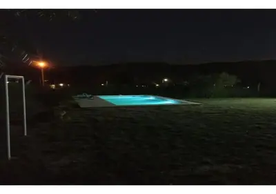 a swimming pool in a field at night at Alquiler temporal casa Bialet Masse con pileta, cancha de fútbol, mesa de pool y ping pong in Bialet Massé