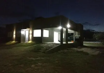 a house lit up at night with lights at Alquiler temporal casa Bialet Masse con pileta, cancha de fútbol, mesa de pool y ping pong in Bialet Massé