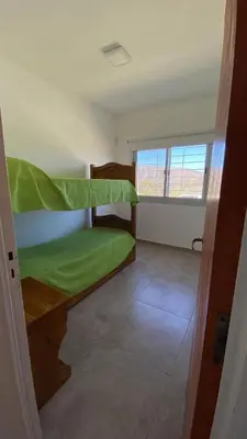 a room with two bunk beds and a window at Alquiler temporal casa Bialet Masse con pileta, cancha de fútbol, mesa de pool y ping pong in Bialet Massé